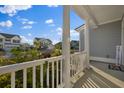 Inviting porch with white columns and railing overlooking a neighborhood at 625 Sienna Way, Summerville, SC 29486