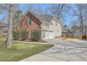 Brick home with attached two-car garage, long driveway, and well-maintained lawn at 659 Hamlet Cir, Goose Creek, SC 29445