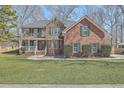 Beautiful two-story brick home with a lush green lawn and traditional green shutters at 659 Hamlet Cir, Goose Creek, SC 29445