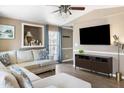 Cozy living room features comfortable sectional sofa, TV, ceiling fan, and hardwood floors at 700 Daniel Ellis Dr # 5302, Charleston, SC 29412