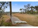Relaxing backyard setting with a hammock and picturesque sunset view at 7759 Edingsville Beach Rd, Edisto Island, SC 29438