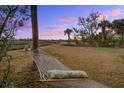 Relaxing backyard setting with a hammock and picturesque sunset view at 7759 Edingsville Beach Rd, Edisto Island, SC 29438
