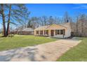 Charming single-story home has a well-manicured lawn and brick facade, complemented by wood shutters at 7783 Peppercorn Ln, North Charleston, SC 29420