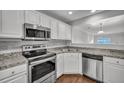 Modern kitchen with stainless steel appliances, granite countertops, and white cabinetry at 804 Buckthorn Cir, Summerville, SC 29483