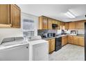 A fully equipped kitchen with wood cabinets, appliances, and a convenient washer and dryer at 111 A Heatley St, Moncks Corner, SC 29461