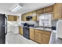 A view of kitchen with wooden cabinets and appliances with adjacent washer and dryer units at 111 A Heatley St, Moncks Corner, SC 29461