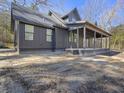 Side view of a modern farmhouse with a covered porch and gray board siding at 1195 Michelle Ln, Johns Island, SC 29455