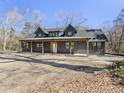 A modern farmhouse with a covered porch featuring wooden support beams at 1195 Michelle Ln, Johns Island, SC 29455