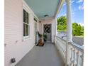 Wide covered porch with blue ceiling, white columns, and a gray front door, creating a welcoming entrance at 12 Percy St, Charleston, SC 29403