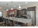 Modern kitchen with granite countertops, stainless steel appliances, and dark wood cabinets at 122 Rockingham Way, Moncks Corner, SC 29461