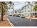 Well-maintained building exterior showcasing ample parking and meticulously kept landscaping, providing a welcoming curb appeal at 130 River Landing Dr # 6207, Charleston, SC 29492