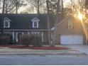 Charming home featuring a well-manicured lawn, dormer windows and a two-car garage at 132 Hidden Fawn Cir, Goose Creek, SC 29445