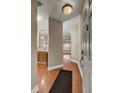 View from the entrance showing wood floors with views into kitchen, living room, and a dark welcome mat at 1505 Basildon Rd, Mount Pleasant, SC 29466