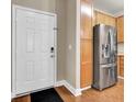 View from the entrance to the kitchen area, highlighting stainless steel refrigerator and wood-grain cabinets at 1505 Basildon Rd, Mount Pleasant, SC 29466