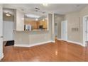 A bright and airy living space with views into the kitchen, hardwood floors, and neutral paint colors at 1505 Basildon Rd, Mount Pleasant, SC 29466