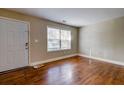 Cozy living area with hardwood flooring, door, and large window at 1556 Larry St, North Charleston, SC 29405