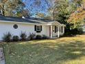 Quaint one-story house with a red door and a well maintained front lawn at 17 Anita Dr, Charleston, SC 29407