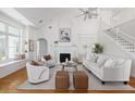 Bright living room with vaulted ceilings, white walls, fireplace, and neutral decor at 184 Scott St, Daniel Island, SC 29492