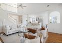 Open-concept living area with high ceilings, hardwood floors, and view of modern kitchen at 184 Scott St, Daniel Island, SC 29492