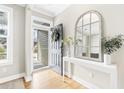 Bright foyer with hardwood floors and elegant decor, leading into the main living spaces of the home at 2005 Nitsa St, Johns Island, SC 29455