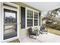 Inviting front porch with seating area, creating a cozy and welcoming entrance to the home at 2005 Nitsa St, Johns Island, SC 29455