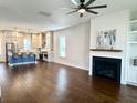 Spacious living room featuring hardwood floors, fireplace with shiplap, and modern finishes at 2014 Codorus Ln, Hanahan, SC 29410