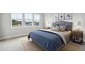 Bedroom with a window view, blue bedding, rug, and matching bedside tables and lamps at 231 Denham St, Summerville, SC 29486
