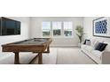 Game room with pool table, sofa, wall mounted TV, and large windows with scenic views at 231 Denham St, Summerville, SC 29486