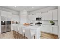 Modern kitchen with stainless steel appliances, marble countertops, island, and white cabinetry at 231 Denham St, Summerville, SC 29486