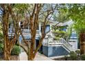 Charming two-story blue home with double garages, second story deck and a white staircase at 2664 Magnolia Woods Dr, Mount Pleasant, SC 29464
