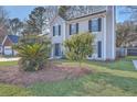 Home exterior showcasing manicured lawn and mature trees in a tranquil setting at 2872 N N. Moss Oak Ln, Charleston, SC 29414