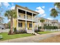 Attractive two-story home with double porches, surrounded by a well-manicured lawn and mature trees at 2876 Rivertowne Pkwy, Mount Pleasant, SC 29466
