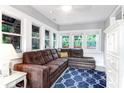 Bright living room with a plush sectional sofa, white trim, and lots of windows at 3 25Th Ave, Isle of Palms, SC 29451