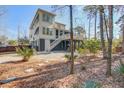 Peaceful backyard view featuring a deck with stairs leading to a wooden fence and lush landscaping at 3575 Holmgren St, Mount Pleasant, SC 29466