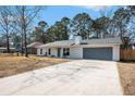 Single-story home with an attached garage, complemented by a well-maintained front yard at 402 Woodward Blvd, Summerville, SC 29483