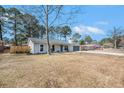 Inviting one-story home featuring a gray exterior, well-kept lawn and attached garage at 402 Woodward Blvd, Summerville, SC 29483