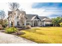 Charming home with a manicured lawn, inviting entryway and a well designed front yard at 4105 Gnarled Oaks Ln, Johns Island, SC 29455