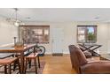 Cozy living area featuring hardwood floors, a dining table, and a comfortable chair near the door at 47 Drake St, Charleston, SC 29403