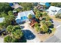Aerial view of a blue beach house surrounded by palm trees in a sunny neighborhood at 5 25Th Ave, Isle of Palms, SC 29451