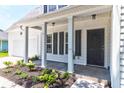 Inviting front porch with classic columns and lush landscaping, enhancing the home's entrance at 506 Cecilia Cove Dr, Charleston, SC 29412