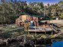 Quaint home features a deck with a hot tub overlooking the water at 5219 Maybank Hwy, Wadmalaw Island, SC 29487