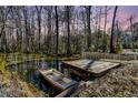 A small boat sits by a pier on a murky waterfront at 5219 Maybank Hwy, Wadmalaw Island, SC 29487