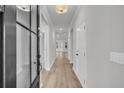 Bright hallway featuring neutral paint, modern lighting, and wood-look flooring at 429 Grove End Rd, Moncks Corner, SC 29461