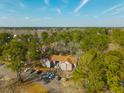 Scenic aerial view of the condo building, surrounded by lush trees and providing a sense of privacy at 7930 Timbercreek Ln # C, North Charleston, SC 29418