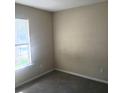 Bright bedroom featuring a window and a neutral color scheme at 7963 Weld St, North Charleston, SC 29418