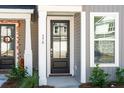A charming front door with sidelight and decorative touches welcomes you to this lovely home at 818 Alma Square Dr, Moncks Corner, SC 29461