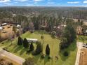 An aerial view shows the property's setting near lush woods and a road, creating a peaceful, accessible environment at 835 Gross Ave, Moncks Corner, SC 29461