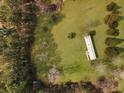 Overhead view showcases the cozy home with a long roof surrounded by trees, and a spacious yard at 835 Gross Ave, Moncks Corner, SC 29461