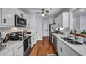 Updated kitchen with white cabinets, stainless steel appliances, and wood-look floors at 87 Ashley Hall Plantation Rd # 108, Charleston, SC 29407
