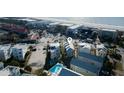 An aerial view shows a coastal community near the beach, with a pool and nearby buildings at 9 J C Long Blvd, Isle of Palms, SC 29451